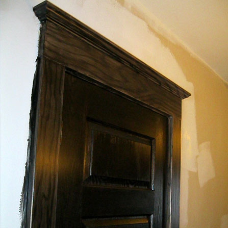 Faux wood grain effect on the door casings next to the oak doors